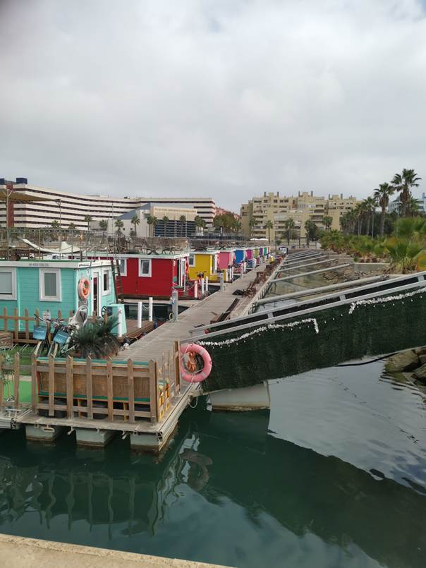 A group of colorful buildings next to a body of water

Description automatically generated with low confidence