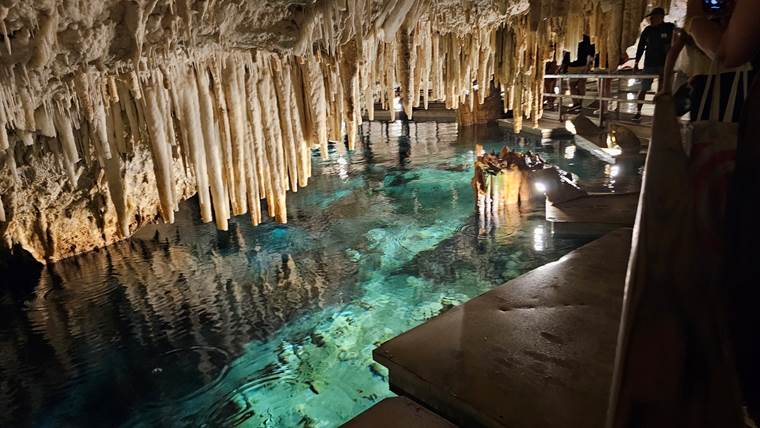 A pool with stalactites and stalagmites

Description automatically generated with low confidence